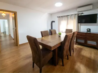 a dining room with a wooden table and chairs at Casa Rustica en Las MONTAÑAS in Tales