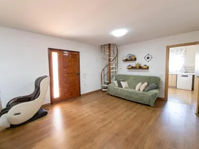 a living room with a couch and a chair at Casa Rustica en Las MONTAÑAS in Tales