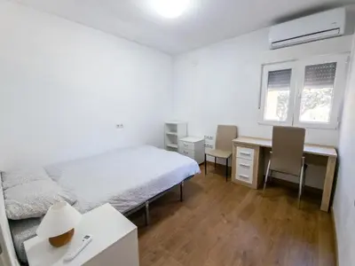a bedroom with a bed and a desk and a desk at Casa Rustica en Las MONTAÑAS in Tales