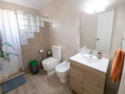 a bathroom with a toilet and a sink and a mirror at Casa Rustica en Las MONTAÑAS in Tales