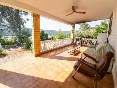 a patio with a table and a chair on it at Casa Rustica en Las MONTAÑAS in Tales