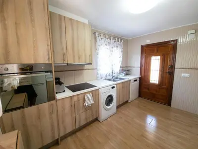 a kitchen with a washing machine and a washer at Casa Rustica en Las MONTAÑAS in Tales
