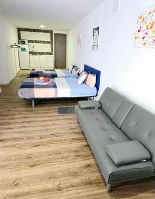 a bedroom with two beds and a couch at Apartamentos Lindux Airport in Manises