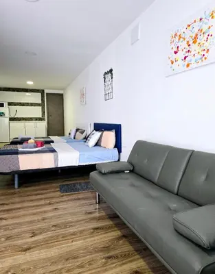 a bedroom with a bed and a couch at Apartamentos Lindux Airport in Manises