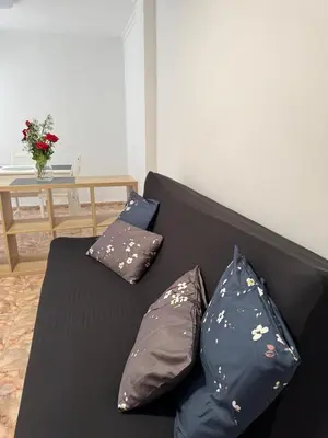 a black couch with three pillows on it at Escapate con estilo en Valencia in Valencia