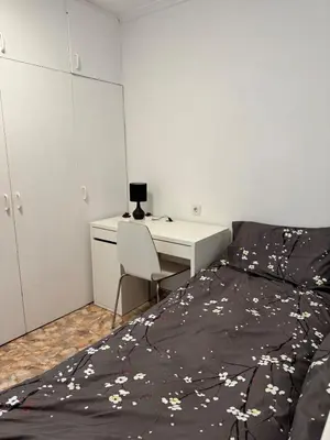 a bedroom with a bed and a desk with a laptop at Escapate con estilo en Valencia in Valencia