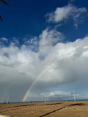 a rainbow in the sky over a beach at Escapate con estilo en Valencia in Valencia