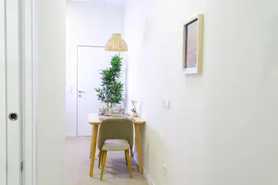 a dining room table with a chair and a plant at PTZ 1B - Loft Valencia in Valencia