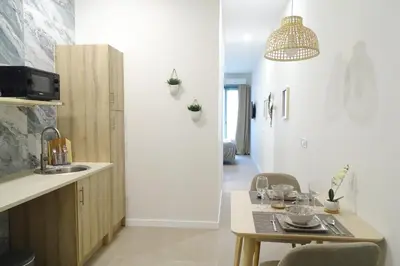 a kitchen with a sink and a table with chairs at PTZ 1B - Loft Valencia in Valencia