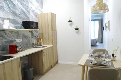 a kitchen with a counter and a table in a room at PTZ 1B - Loft Valencia in Valencia