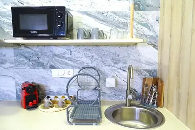 a kitchen counter with a sink and a microwave at PTZ 1B - Loft Valencia in Valencia