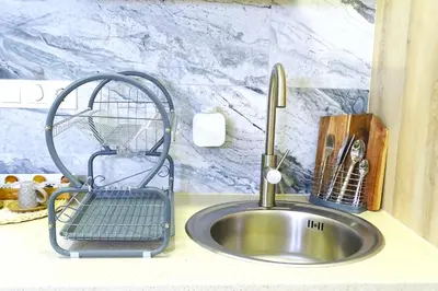 a kitchen sink with a dish drying rack next to it at PTZ 1B - Loft Valencia in Valencia