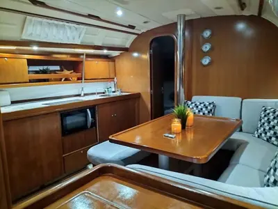 a kitchen and a dining room with a table at Magnificent sailboat with free parking for cars in Valencia