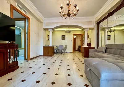 a living room with a couch and a table at Wagner Playa Apartment in Cullera