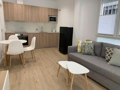 a living room with a couch and a table and chairs at Nieuw Appartement in El Carmen in Valencia