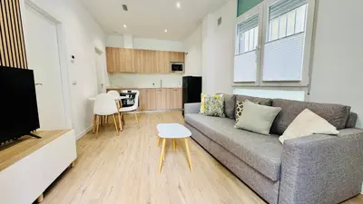 a living room with a couch and a table at Nieuw Appartement in El Carmen in Valencia