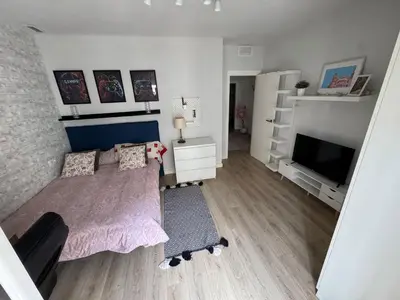 a bedroom with a bed and a flat screen tv at Habitación en el centro con balcón in Valencia