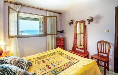 a bedroom with a bed and a window at Lovely Apartment In Faro De Cullera in Faro de Cullera