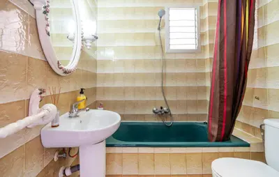 a bathroom with a sink and a bath tub at Lovely Apartment In Faro De Cullera in Faro de Cullera