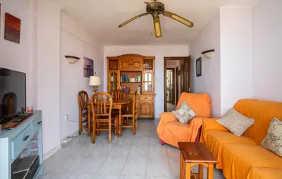 a living room with a couch and a table at Lovely Apartment In Faro De Cullera in Faro de Cullera
