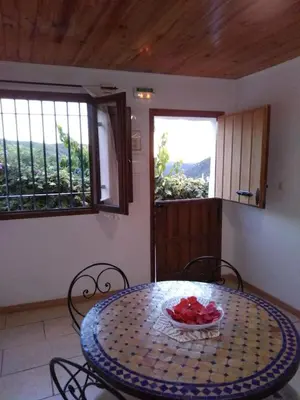 a table and chairs with a bowl of fruit on it at Les Eres de Gátova in Gátova