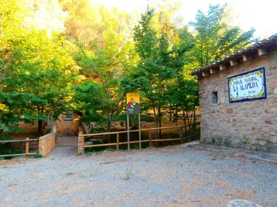 a building with a sign next to a fence at Les Eres de Gátova in Gátova