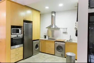 a kitchen with a washer and dryer at Cozy apartment in the old town - San Ramon in Valencia