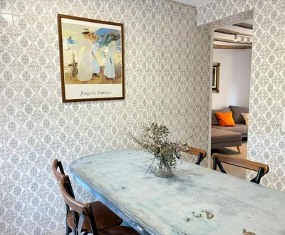 a dining room with a table and a picture on the wall at Your stylish retreat in Sierra Espadán in Vall de Almonacid