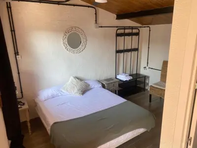 a bedroom with a bed and a mirror on the wall at La Terreta hotel casa rural in El Brosquil