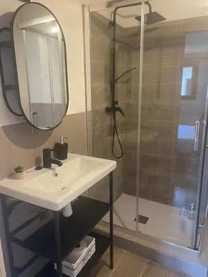 a bathroom with a sink and a shower with a mirror at La Terreta hotel casa rural in El Brosquil