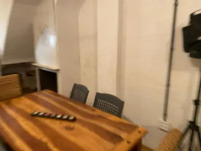 a wooden table and chairs in a room at La Terreta hotel casa rural in El Brosquil