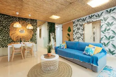a living room with a blue couch and a table at Tiny Valencia Gem - 2BR - Relax in Valencia