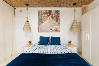 a bedroom with a blue bed with two blue pillows at Tiny Valencia Gem - 2BR - Relax in Valencia