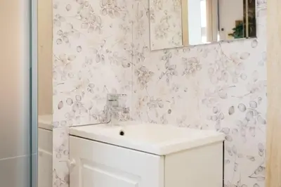 a white bathroom with a sink and a mirror at Tiny Valencia Gem - 2BR - Relax in Valencia