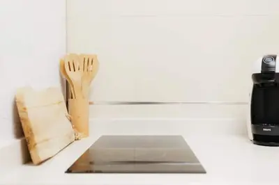 a kitchen counter with a knife and fork and a cutting board at Tiny Valencia Gem - 2BR - Relax in Valencia