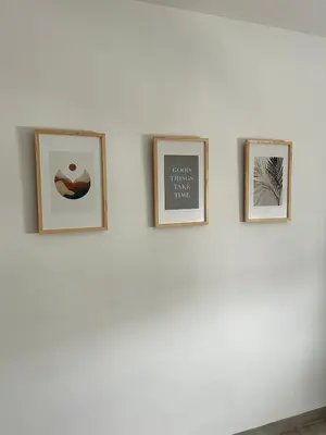 four framed pictures on a white wall at Abadesa Apartments in Benetúser
