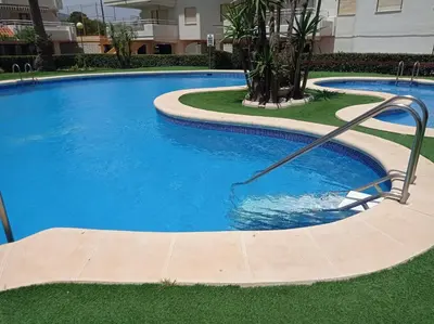 a large swimming pool with a water hose in it at Perla III Solo Familias Serviplaya in Casas Las Basas