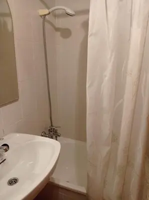 a bathroom with a sink and a shower curtain at Perla III Solo Familias Serviplaya in Casas Las Basas