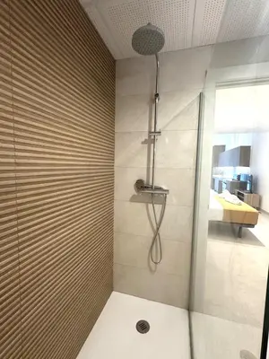 a bathroom with a shower with a glass door at Marina Azura in Valencia