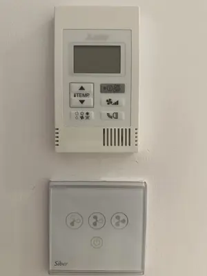 a white microwave hanging on a wall at Marina Azura in Valencia