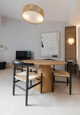 a table and chairs in a room with a lamp at Marina Azura in Valencia