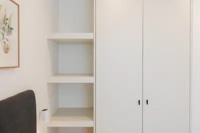 a closet with white cabinets in a room at Doce de Colón C in Requena