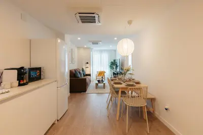 a kitchen and living room with a table and chairs at Doce de Colón C in Requena