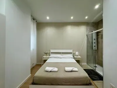 a bedroom with a bed with two towels on it at Reino Vlc - centrico y amplio piso in Valencia