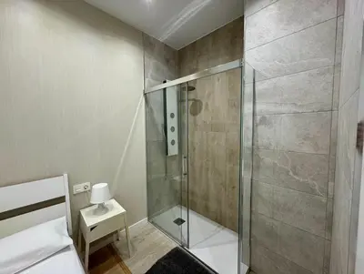 a shower with a glass door in a bathroom at Reino Vlc - centrico y amplio piso in Valencia