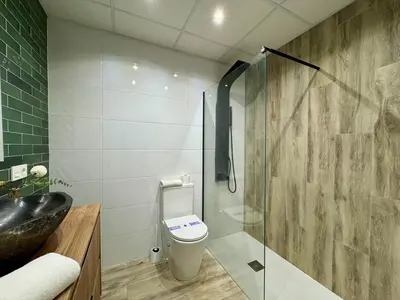 a bathroom with a toilet and a glass shower at Reino Vlc - centrico y amplio piso in Valencia