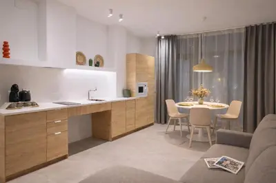 a kitchen and dining room with a table and chairs at Olmaya Flats Valencia in Valencia