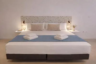 a bedroom with a large bed with towels on it at Olmaya Flats Valencia in Valencia