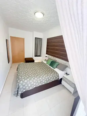 a bedroom with a large bed with a wooden headboard at Casa Burriana con sauna in Burriana
