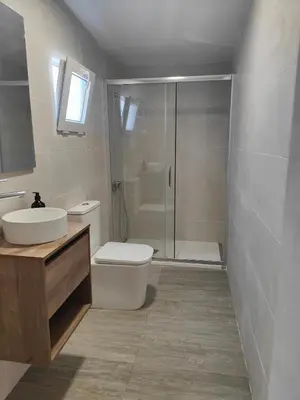a bathroom with a toilet and a sink and a shower at Chalet con piscina dogfriendly in Algar de Palancia